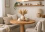 Cozy small apartment dining nook with round wooden table, neutral Scandinavian decor, and soft pendant lighting.